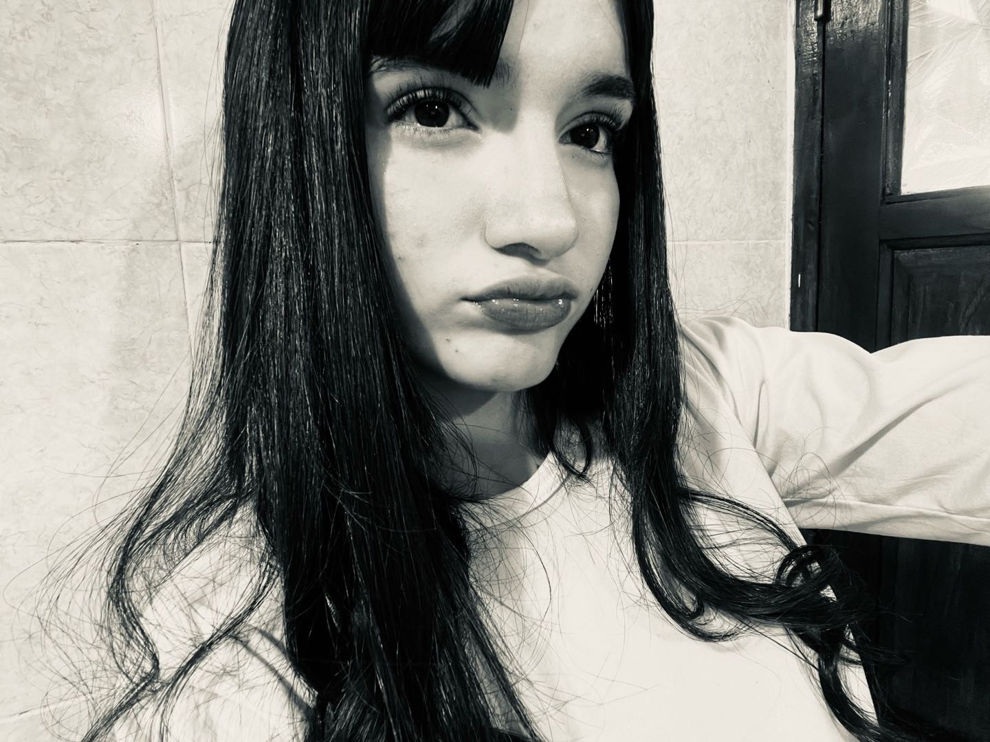 Lucía in a black-and-white selfie, calm and candid